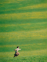 Woman Running in Green Field Wall Art Print